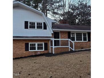 Charming brick home featuring a mix of modern white siding and traditional design elements at 2300 Radius Cir, Sanford, NC 27330