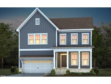 Two-story home with gray siding, white trim, and a two-car garage at 231 Circle City Way, Pittsboro, NC 27312