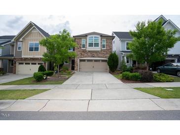 Brick front two-story home with attached two-car garage and landscaping at 248 Begen St, Morrisville, NC 27560