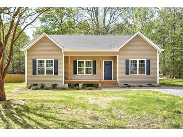 Charming single-story home with blue shutters, light siding, and a welcoming front porch at 2857 Greenbrook Dr, Wendell, NC 27591