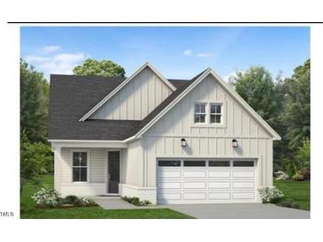 Two-story craftsman style home with gray siding, white trim, and a two-car garage at 524 Gainer Dr # 7, Raleigh, NC 27610