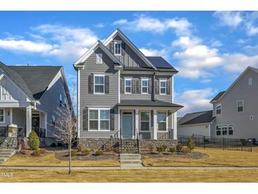 Gray two-story home with stone accents and solar panels at 6134 Giddings St, Raleigh, NC 27616