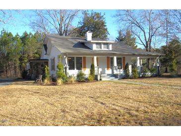 Charming white craftsman home with a wraparound porch and manicured lawn at 815 N Durham Ave, Creedmoor, NC 27522