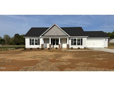 Charming single-story home with black shutters, a gray roof, and a spacious two-car garage at 69 N Movado Trl, Kenly, NC 27542