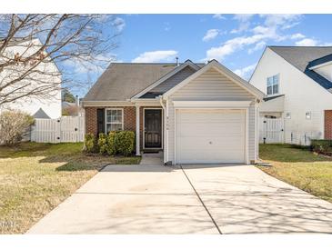 Brick ranch home with attached garage and landscaped yard at 9104 Colony Village Ln, Raleigh, NC 27617