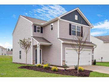Two-story house with gray siding, white garage door, and landscaping at 103 Scoville St, Oxford, NC 27565