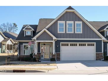 Gray two-story house with white garage door and landscaping at 116 Telluride Trl, Garner, NC 27529