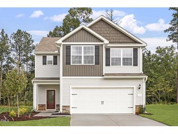 Two-story house with neutral siding, a double garage, and landscaping at 207 Shelfit Trl, Oxford, NC 27565