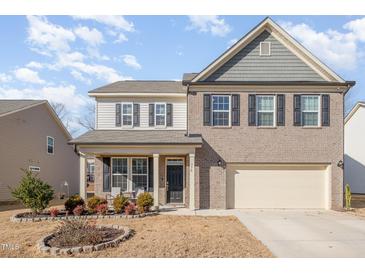 Two-story brick home with a landscaped front yard and attached garage at 370 Hickory Run Ln, Franklinton, NC 27525