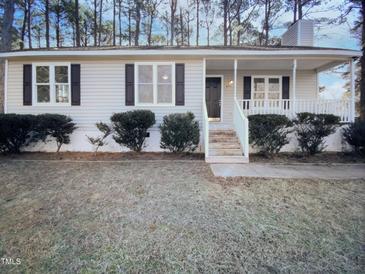 Ranch style home with front porch and well-manicured lawn at 4532 Hidden Hollow Ln, Knightdale, NC 27545