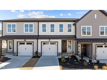 Charming townhouse featuring a two-car garage, well-maintained landscaping, and neutral color scheme at 610 Marshskip Way, Rolesville, NC 27587