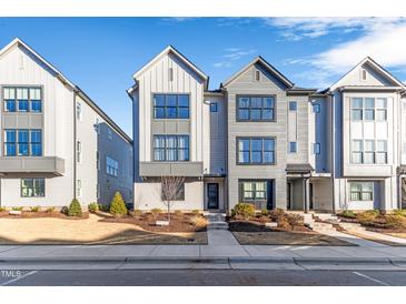 Three-story townhouses with gray siding, modern design, and landscaping at 1179 Cottonsprings Dr, Wendell, NC 27591