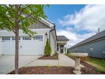 Charming home featuring an attached garage, well-manicured lawn, and inviting curb appeal at 212 War Admiral Dr, Clayton, NC 27520