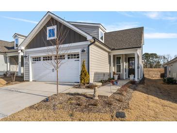 Two-story Craftsman style home with a two car garage and landscaped front yard at 212 War Admiral Dr, Clayton, NC 27520