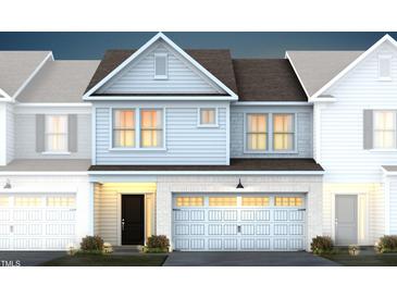 Two-story townhome with gray siding, dark roof, and two-car garage at 299 Broomside Ave, Raleigh, NC 27603