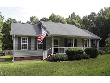Gray house with white trim, gray shutters, and a white porch at 3413 Thistledown Ct, Efland, NC 27243
