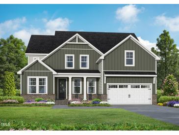 Two-story house with green siding, white trim, and a two-car garage at 4816 Bristol Meadow Dr, Raleigh, NC 27603