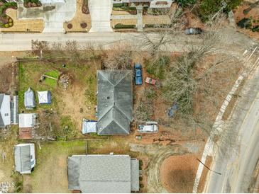 Aerial view of a house and surrounding property, including yard and neighboring houses at 517 Kildaire Farm Rd, Cary, NC 27511