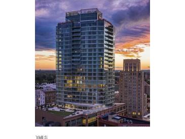 High-rise building with modern glass exterior in urban setting at 110 N Corcoran St # 2104, Durham, NC 27701