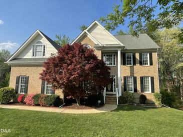 Charming brick two-story home with manicured lawn and mature landscaping at 112 Gingergate Dr, Cary, NC 27519