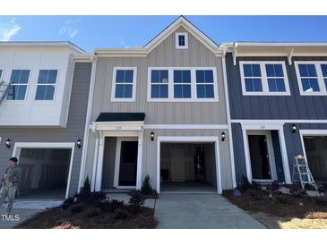 Charming townhome with a one-car garage and traditional architectural design at 115 Central Townes Way # 300, Raleigh, NC 27603