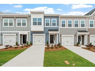Charming townhomes featuring modern design, individual garages, and beautifully landscaped front yards at 120 Fideaux Blvd # 257, Raleigh, NC 27603