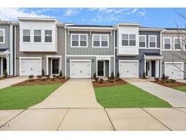 Charming townhomes with attached garages, lovely lawns, and neutral color schemes at 124 Fideaux Blvd # 256, Raleigh, NC 27603