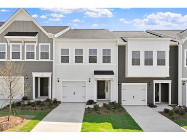 Modern townhome exteriors showcasing stylish designs and well-manicured lawns under a partly cloudy sky at 148 Fideaux Blvd # 250, Raleigh, NC 27603