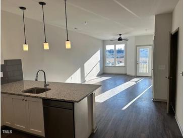 Modern kitchen with stainless steel appliances and granite countertops at 2225 Gathering Square Ct # 2225, Fuquay Varina, NC 27526