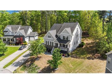 Charming two-story home with manicured lawn and inviting front porch at 3308 Eden Grove Rd, Fuquay Varina, NC 27526