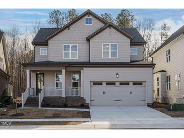 Charming two-story home with a covered porch, neutral siding, and an attached two-car garage at 116 Bearwallow Forest Way, Wendell, NC 27591