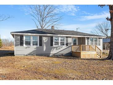 Charming single-story home with gray siding, black shutters, and a cozy front porch under a blue sky at 2041 Grassy Creek Virgilina Rd, Oxford, NC 27565