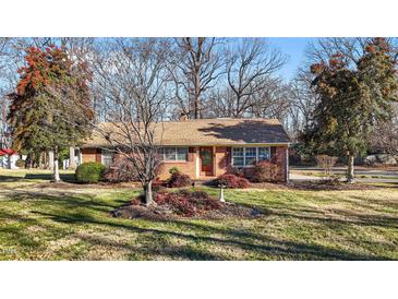 Brick ranch house with landscaped yard at 307 E Jackson St, Mebane, NC 27302
