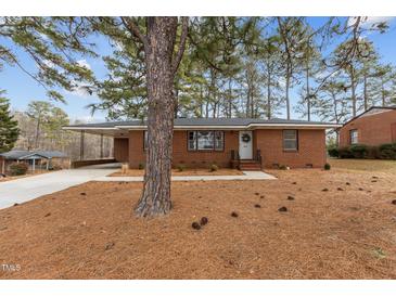 Brick ranch house with a large front yard and mature trees at 416 N Cheatham St, Franklinton, NC 27525