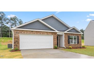 Brick and gray siding house with 2 car garage at 858 Forth Ct, Gibsonville, NC 27249