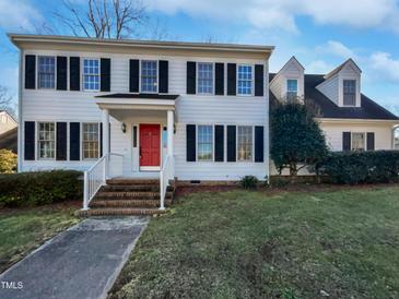 Two story home with red front door and manicured lawn at 118 Trafalgar Ln, Cary, NC 27513