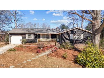 Charming single-story home with a well-maintained front yard and inviting covered porch at 1219 Carlton Ave, Burlington, NC 27217