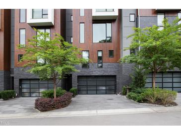 Modern townhouses with attached garages and landscaping at 202 Dundas Ln, Raleigh, NC 27603