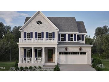 Two-story home with gray brick exterior, white trim, and a two-car garage at 2618 Marchmont St, Raleigh, NC 27608
