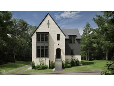 Two-story house with white brick and gray siding, a gabled roof, and a front porch at 2650 Marchmont Street St, Raleigh, NC 27608