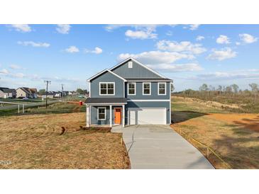 New construction two-story home with blue siding and an orange front door at 2995 Faucette Ln, Burlington, NC 27217