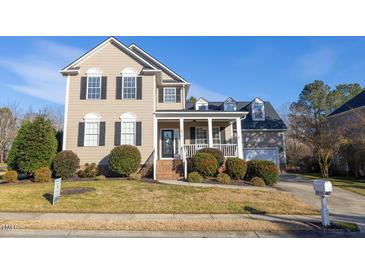 Charming two-story home with manicured lawn, inviting front porch, and traditional architectural details at 30155 Pharr, Chapel Hill, NC 27517