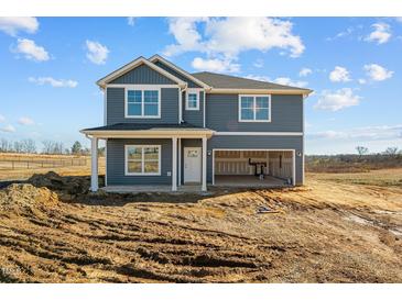 Two-story house featuring a gray exterior, two-car garage, and front porch at 3615 Nc-62, Burlington, NC 27217