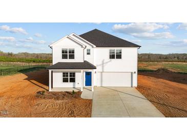 Charming two-story white home with a blue front door and attached garage at 3655 Nc-62, Burlington, NC 27217