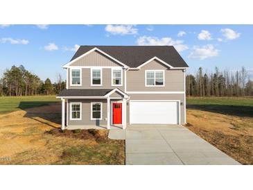 Charming two-story home features a gray exterior, red front door, and attached two-car garage at 3689 Nc 62, Burlington, NC 27217