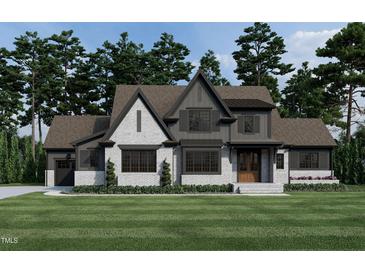 Two-story house with gray and white brick exterior, and a gabled roof at 3813 Peaceful Creek Trl, Zebulon, NC 27597