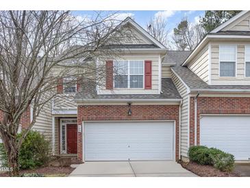 Charming two-story home with brick accents, red shutters, and a two-car garage at 749 Swan Neck Ln, Raleigh, NC 27615