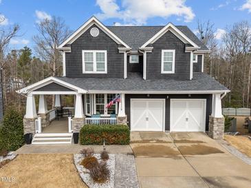 Two-story home with gray siding, white trim, and a two-car garage at 101 Pointe Park Cir, Holly Springs, NC 27540