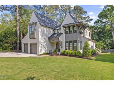 Stunning two-story home featuring a landscaped front yard and a convenient two-car garage at 1304 Ivy Ln, Raleigh, NC 27609