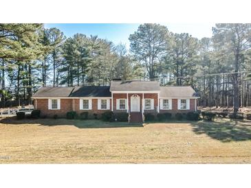 Brick ranch house with a spacious yard and mature trees at 3129 Barwell Rd Rd, Raleigh, NC 27610